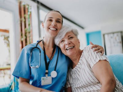 Home care healthcare professional hugging senior patient